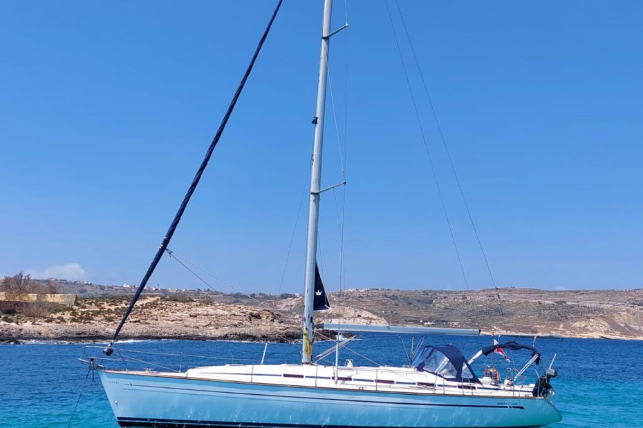 Group boarding a yacht in a marina with multiple charter boat sizes