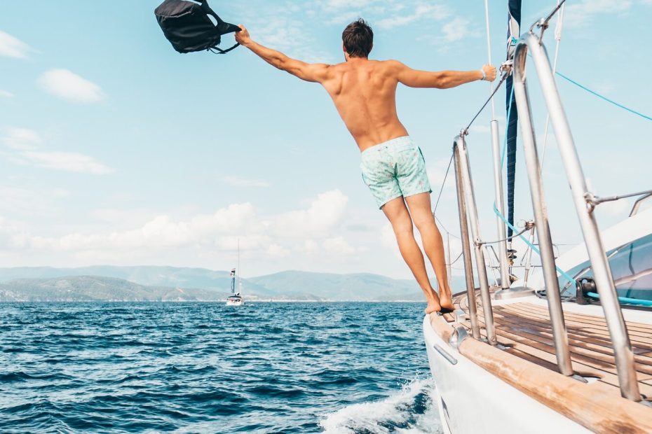 Sailing yacht and catamaran on open sea for boat type comparison